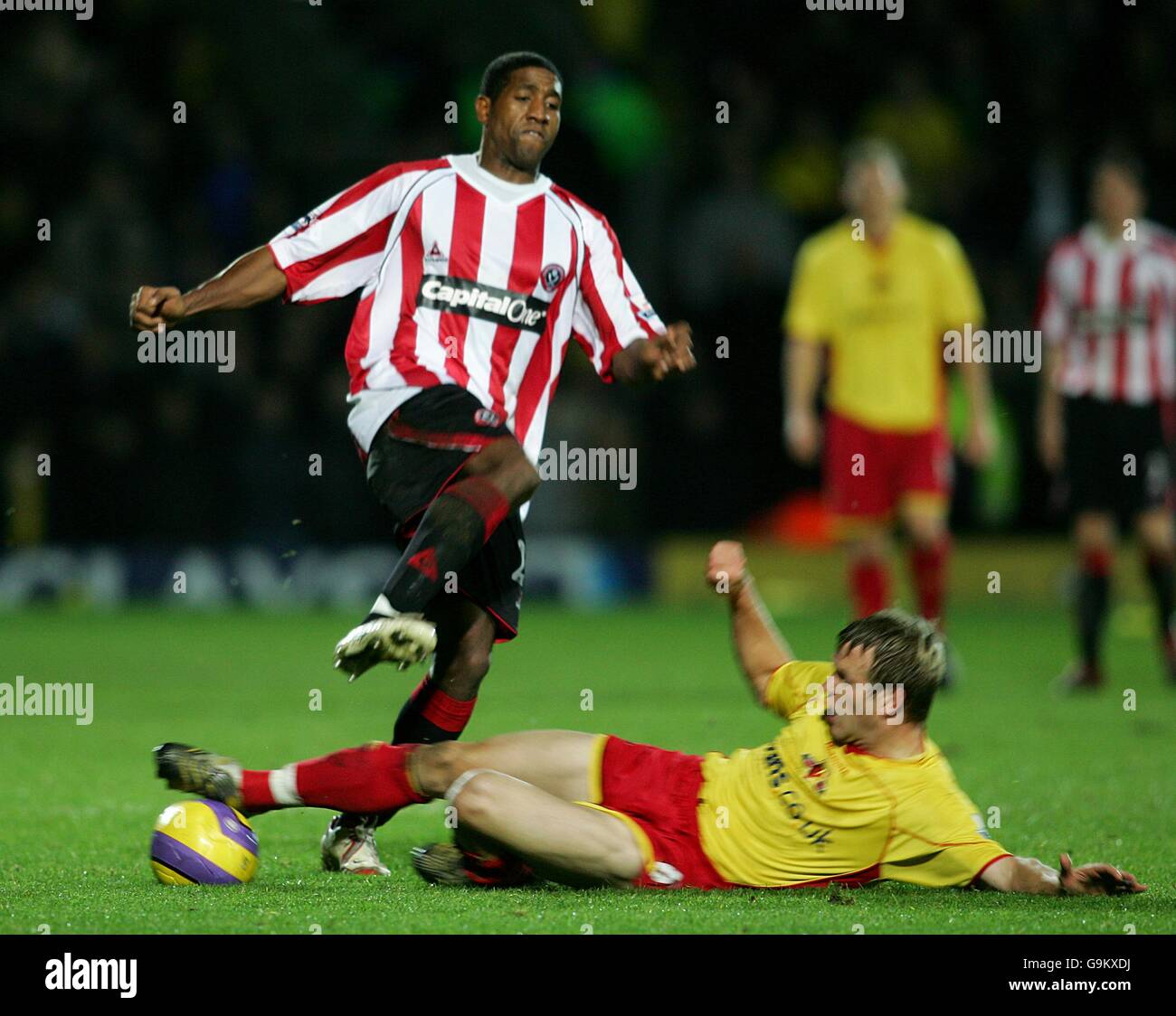 Soccer - FA Barclays Premiership - Watford v Sheffield United - Vicarage Road. Sheffield United's Mikele Leigertwood (l) jumps an oncoming tackle from Watford's Jay DeMerit Stock Photo