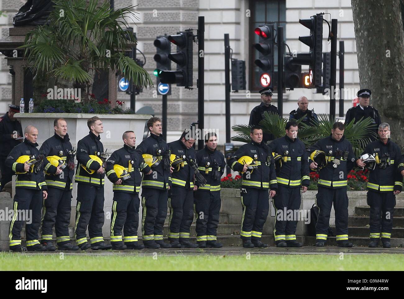 Members of the London Fire Brigade pay their respects after the King's Troop Royal Horse Artillery fire First World War guns in Parliament Square, London, to mark the end of the vigil at the grave of the Unknown Warrior in Westminster Abbey, as the nation honours thousands of soldiers killed in the Battle of the Somme, 100 years after its bloody beginning. Stock Photo