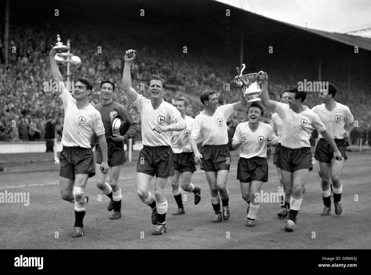 Tottenham Hotspur celebrate with the FA Cup after their 2-0 win secured The Double: (l-r) Ron Henry, Bill Brown, Peter Baker, Cliff Jones, Danny Blanchflower, Terry Dyson, Les Allen, Bobby Smith, Maurice Norman Stock Photo