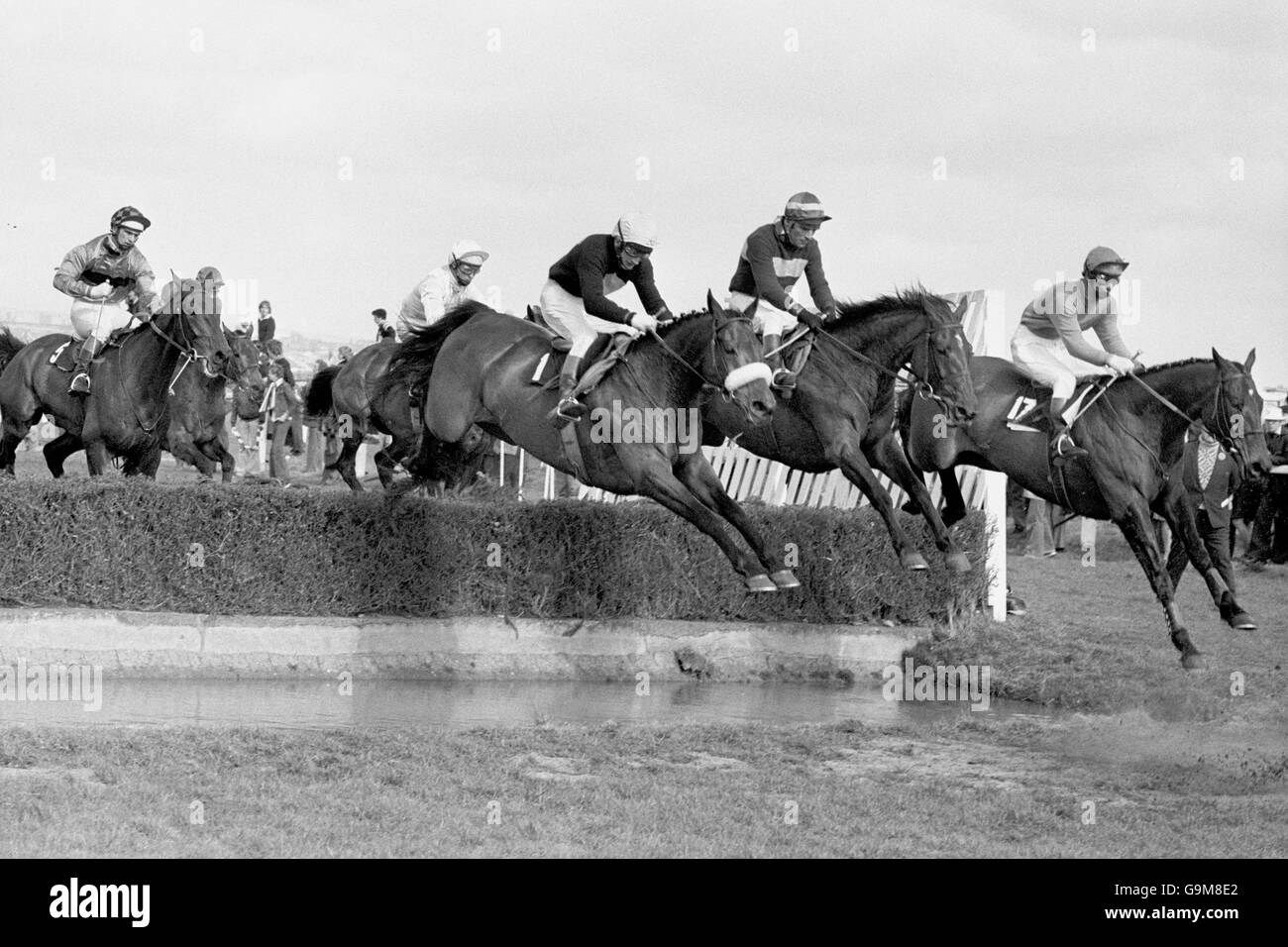 Red Rum ridden by Tommy Stack taking the water jump for the first time with Roman Bar ridden by P.Kiely (c) and Brown Admiral ridden by S.Morshead Stock Photo