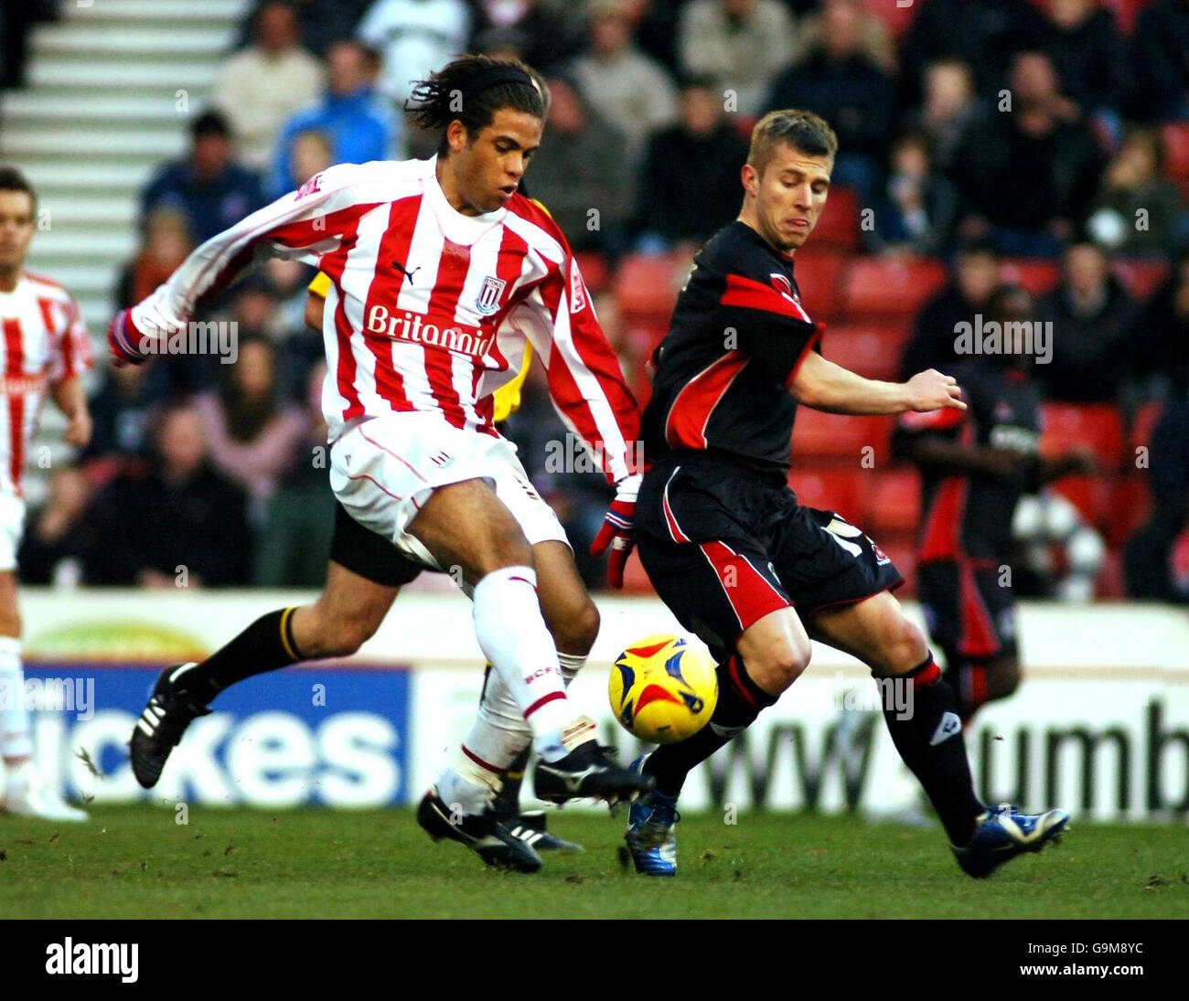 Stoke City's Darel Russell and Queens Park Rangers' Martin Rowlands battle for the ball during the Coca-Cola Championship match at the Britannia Stadium, Stoke. Stock Photo