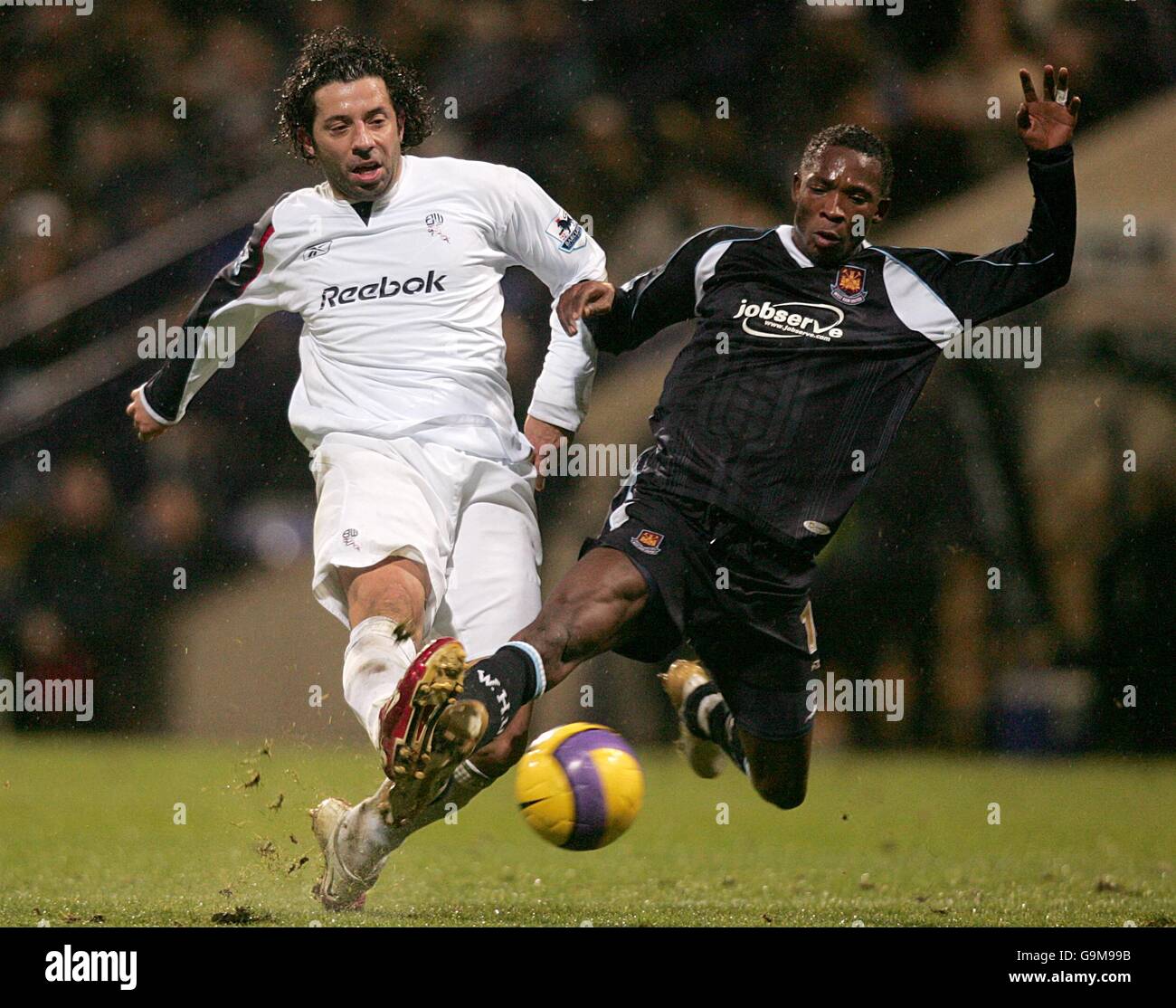 Soccer - FA Barclays Premiership - Bolton Wanderers v West Ham United - The Reebok Stadium. West Ham United's John Pantsil is challenged by Bolton Wanderer's Ivan Campo Stock Photo