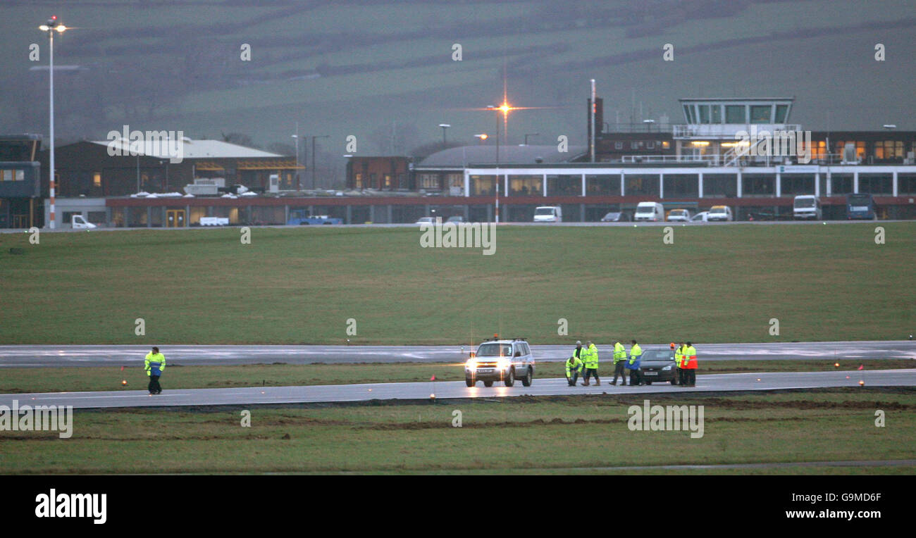 Staff inspect the runway at Bristol International Airport this morning, after staff worked through the night to improve the drainage problem which has led to the cancellation of flights. Stock Photo