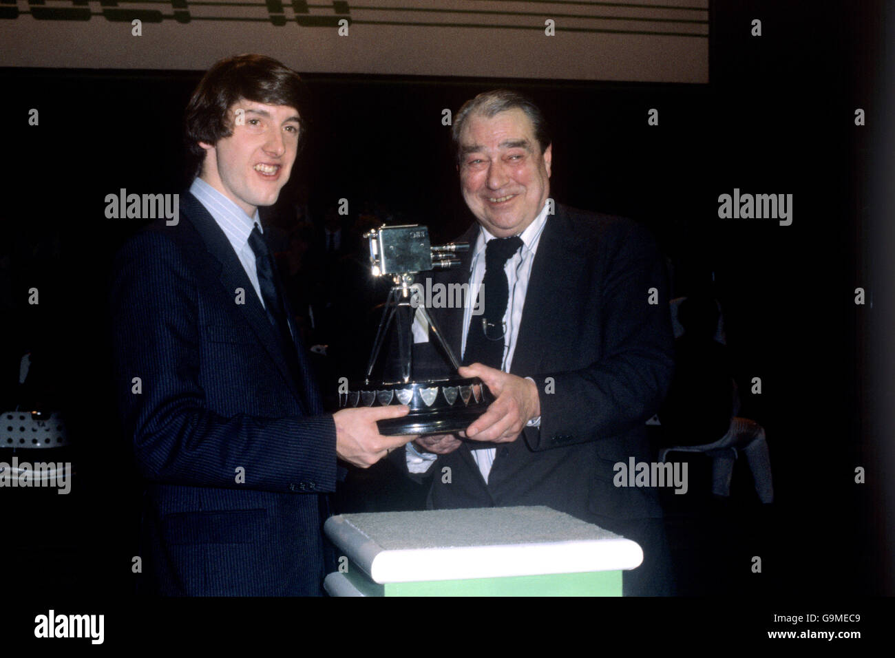 Olympic figure skating gold medallist Robin Cousins is presented with the BBC Sports Personality of the Year award by cricket commentator John Arlott Stock Photo