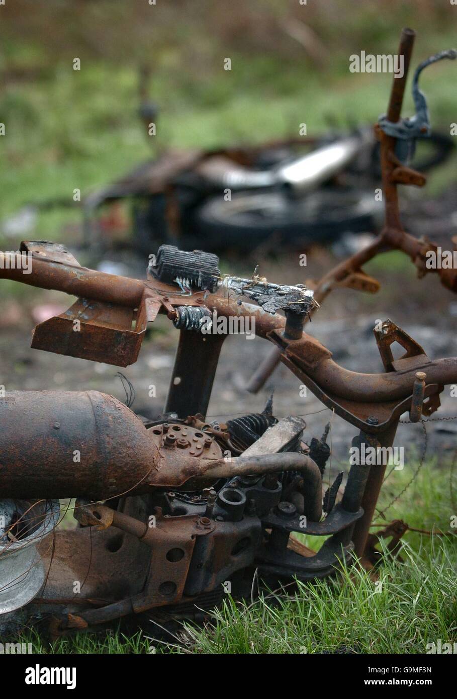 Burned-out motor scooters on a walkway in Stratford, east London, on the edge of the 2012 Olympic development area. Stock Photo