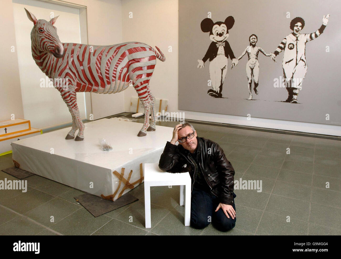 British artist Damien Hirst sits some works from 'murderme', his personal contemporary art collection, which he is exhibiting at London's Serpentine Gallery from tomorrow. Stock Photo