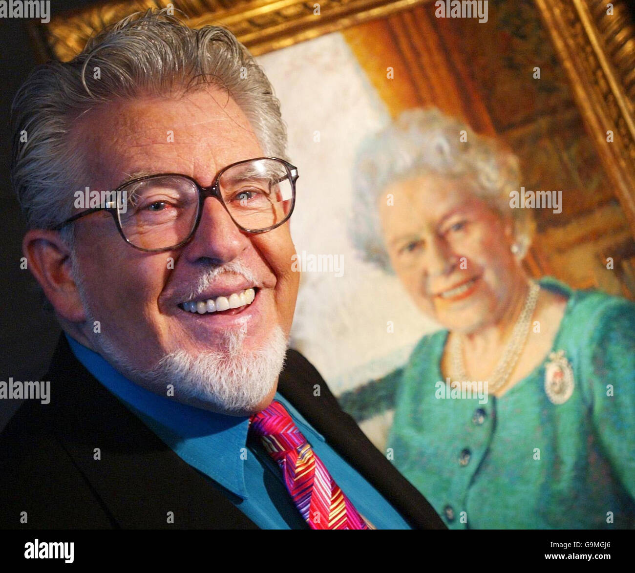 Rolf Harris chats to members of the press about his portrait of Her