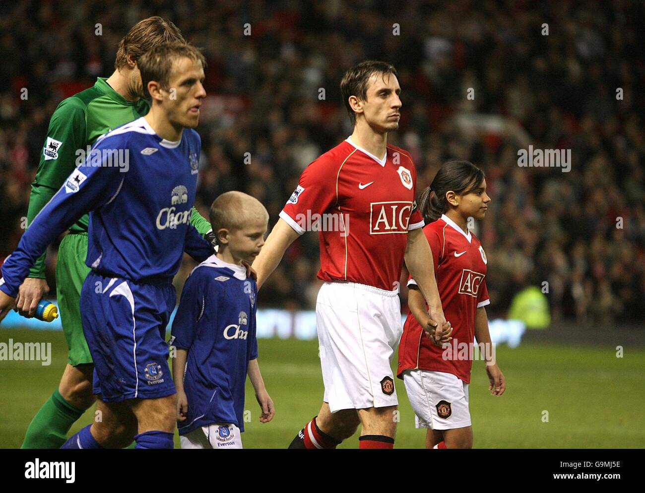 Manchester United captain Gary Neville and Everton captain Phil Neville lead out the teams prior to the game Stock Photo