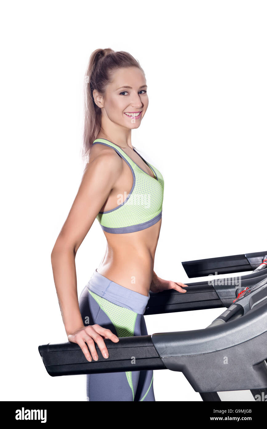 attractive young woman runs on a treadmill, is engaged in fitness sport club Stock Photo