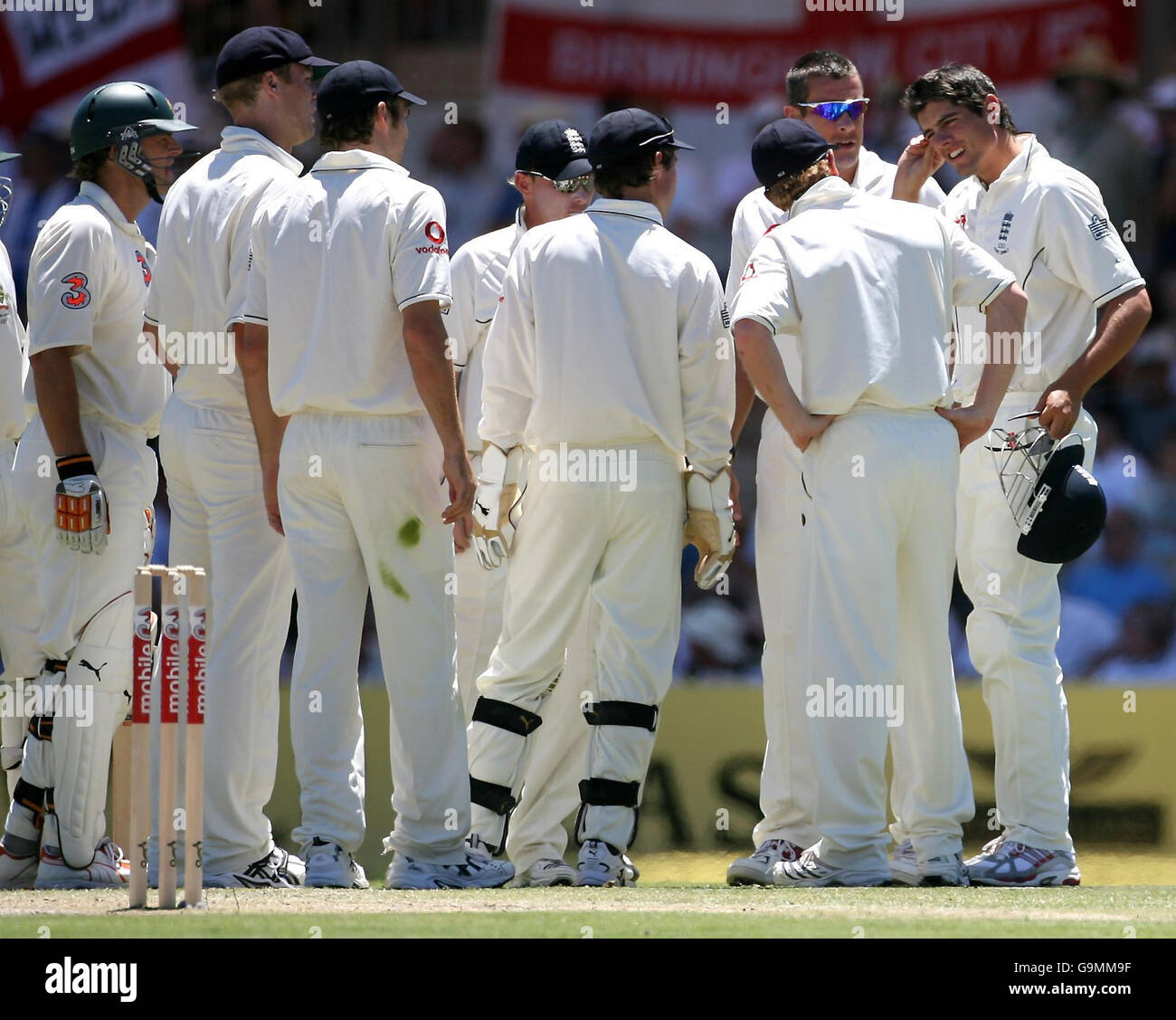 England's Alastair Cook(right) rubs his head been hit by a shot from Australia's Adam Gilchrist (left) during the fourth day of the second Test match at the Adelaide Oval, Adelaide, Australia. Stock Photo
