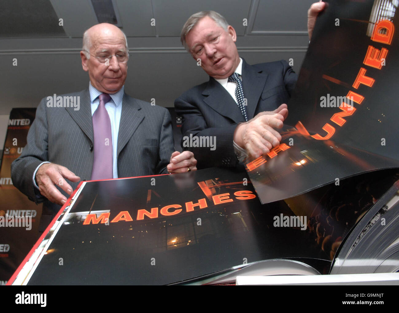 Sir Bobby Charlton and Sir Alex Ferguson turn the pages of the 'Manchester United Opus', a book measuring half a metre square and weighing 37 kilograms depicting the life of the famous football club. Stock Photo
