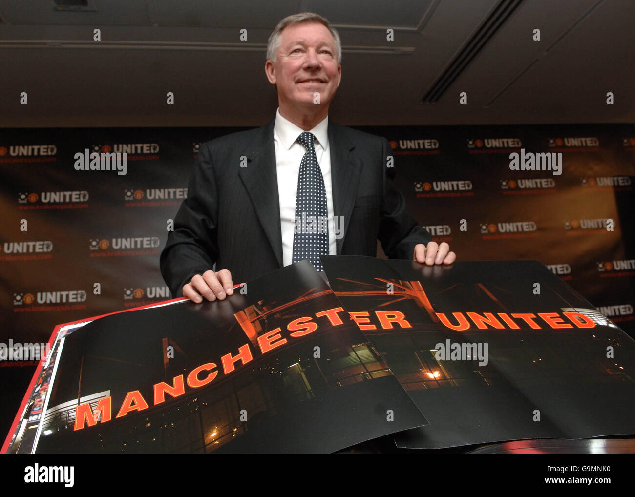 Manager Sir Alex Ferguson turn the pages of the 'Manchester United Opus', a book measuring half a metre square and weighing 37 kilograms depicting the life of the famous football club. PRESS ASSOCIATION Photo. Stock Photo