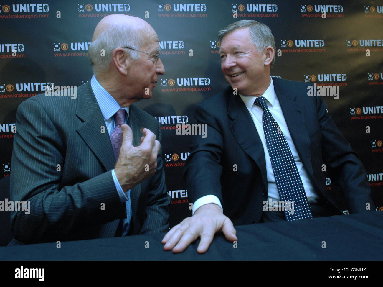Club legend Sir Bobby Charlton, left, and current manager Sir Alex Ferguson at the launch of the 'Manchester United Opus', a book measuring half a metre square and weighing 37 kilograms depicting the life of the famous football club. Stock Photo