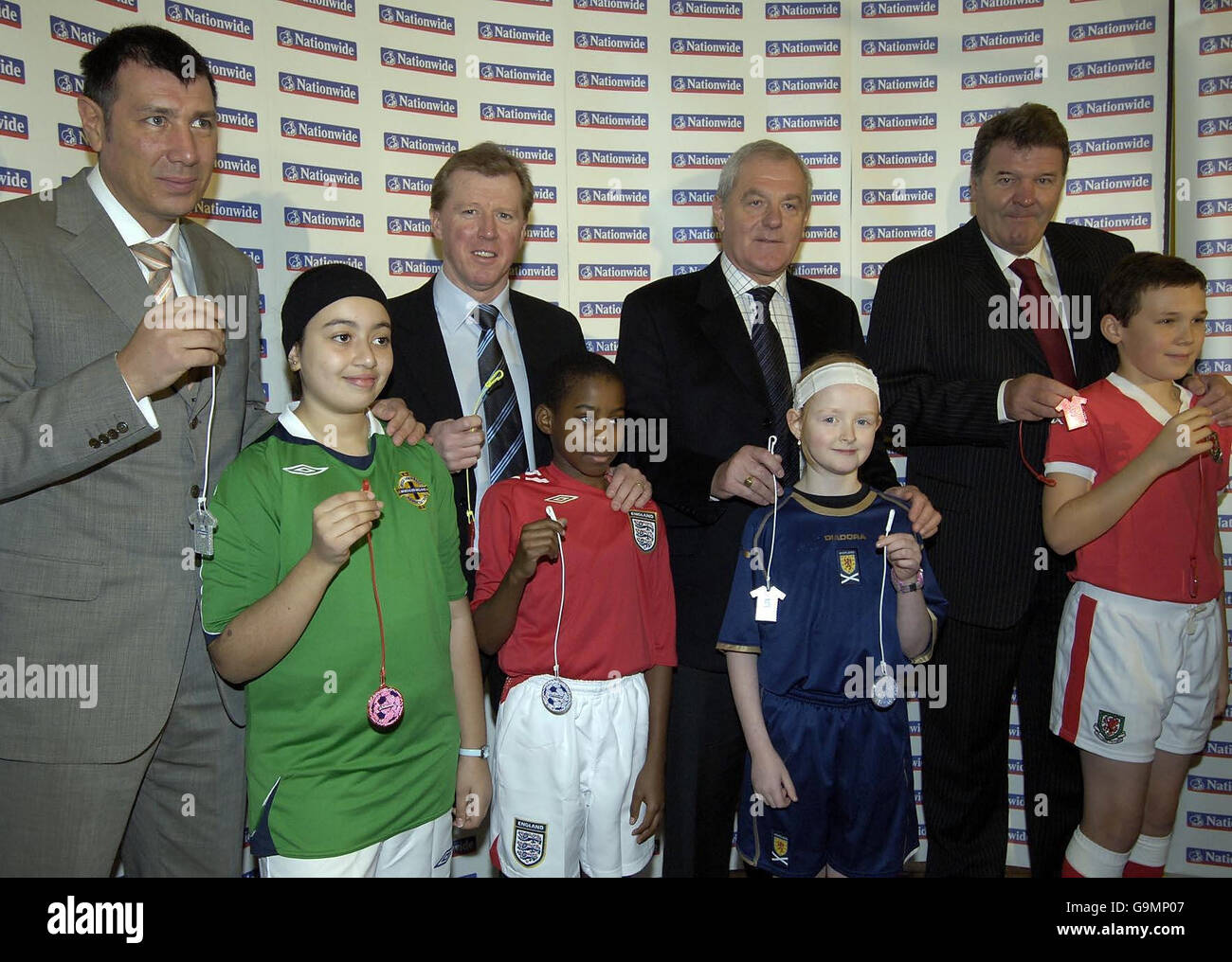 Four Home Nation Managers (L-R) Northern Ireland manager Lawrie Sanchez with Iman Less, Eng; and manager Steve McClaren with Louis Jemmott, Scottland manager Walter Smith with Sarah Braster and John Toshack with Alex Adams during the launch of the 'Cats Eyes For Kids' scheme at St George's Primary School, London. Stock Photo
