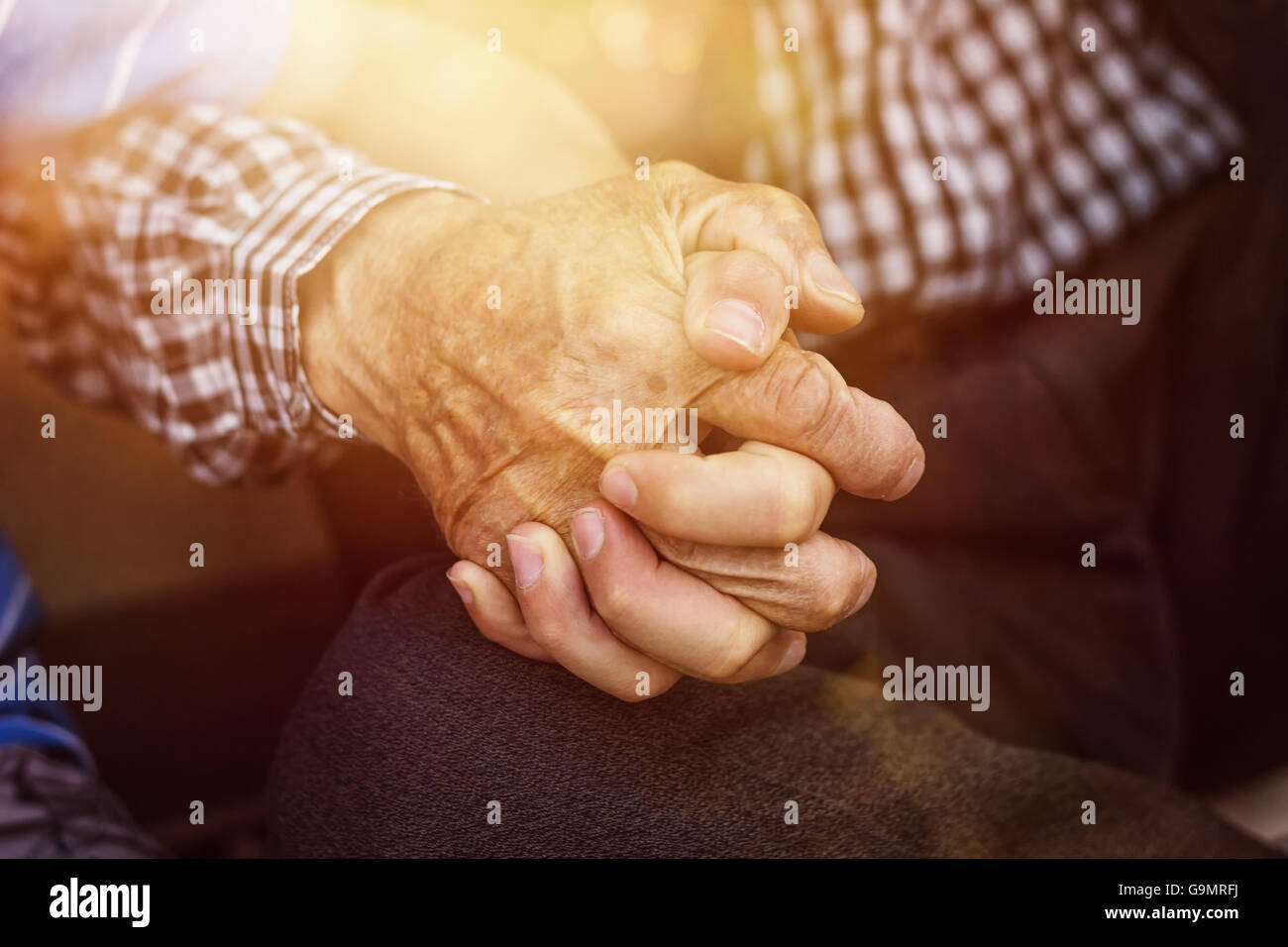 nephew holding strong grandfather's hand Stock Photo