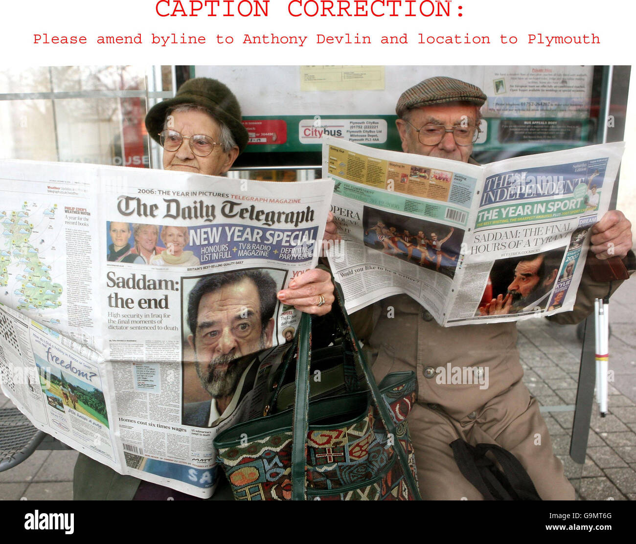 CAPTION CORRECTION. Amended caption should read: Members of the public in Plymouth read the news that former Iraqi dictator Saddam Hussein was executed at dawn today in Baghdad, Iraq (3am GMT). Stock Photo