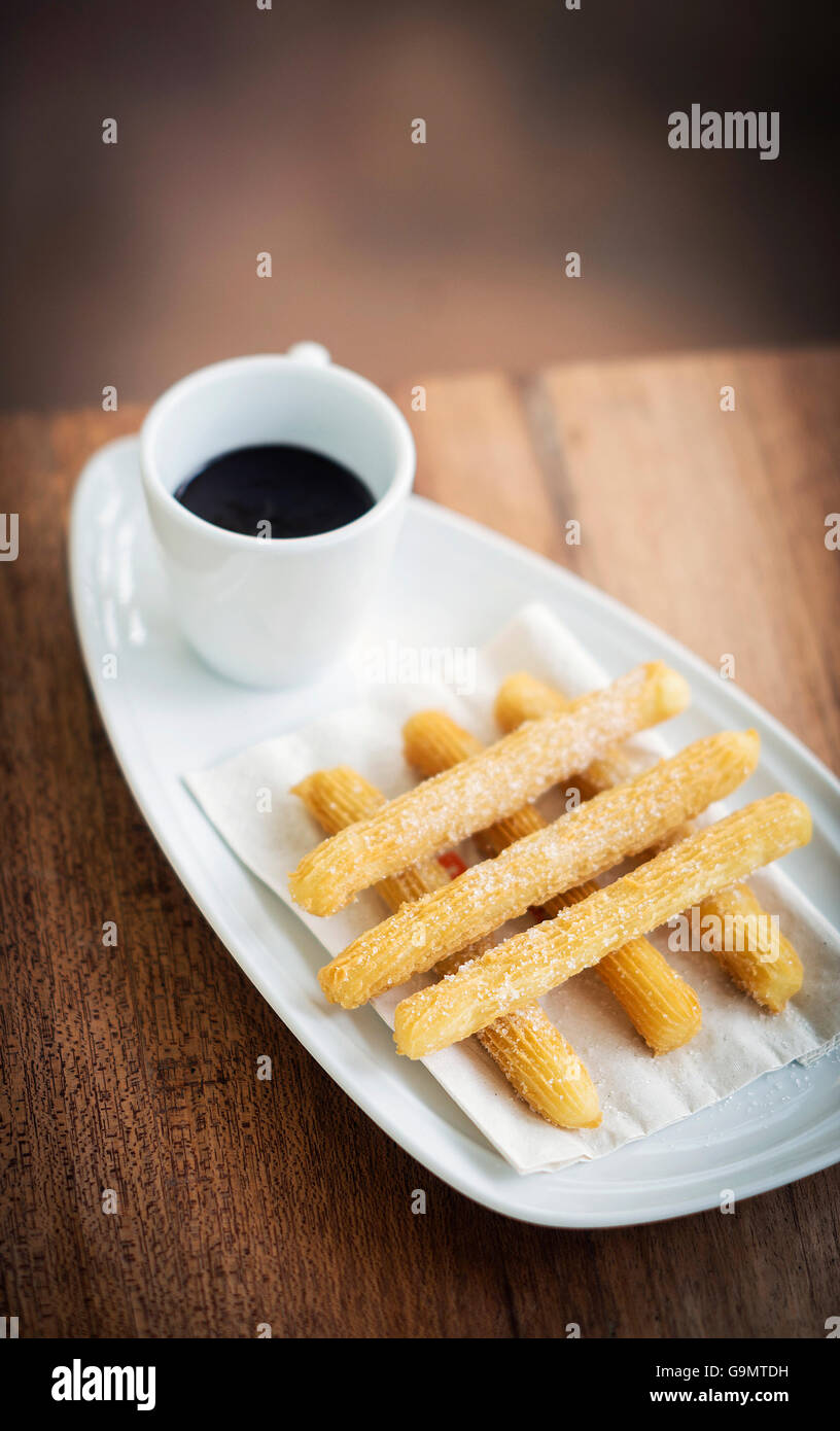churros and chocolate spanish donuts pastry doughnuts with sauce