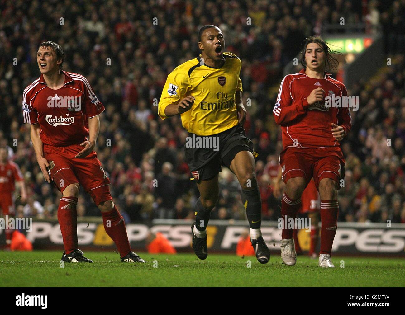 Arsenal's Julio Baptista celebrates his goal as Liverpool's Stephen Warnock and Gabriel Paletta stand dejected Stock Photo