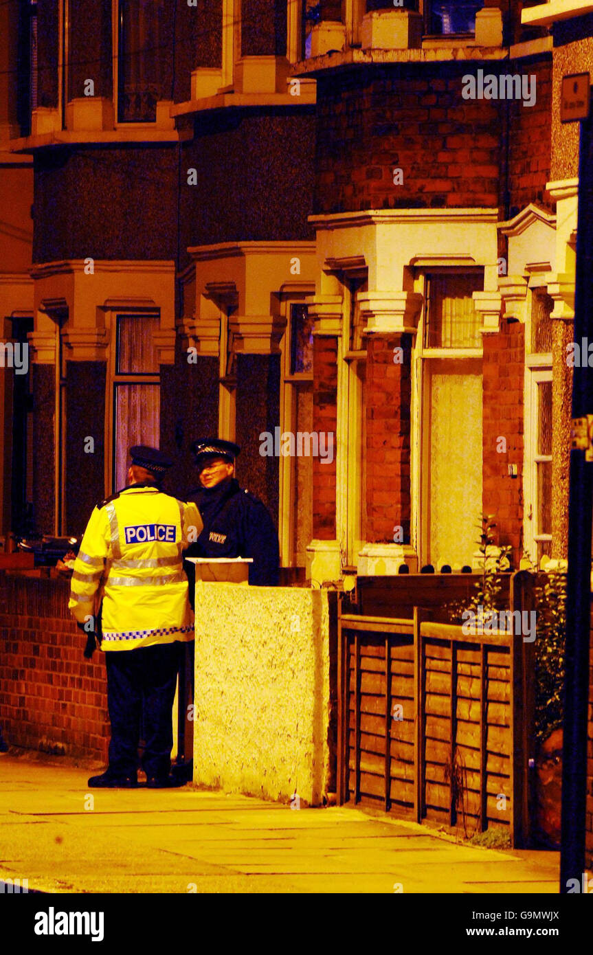 Police officers stands outside a house in Nelson Street, in East Ham