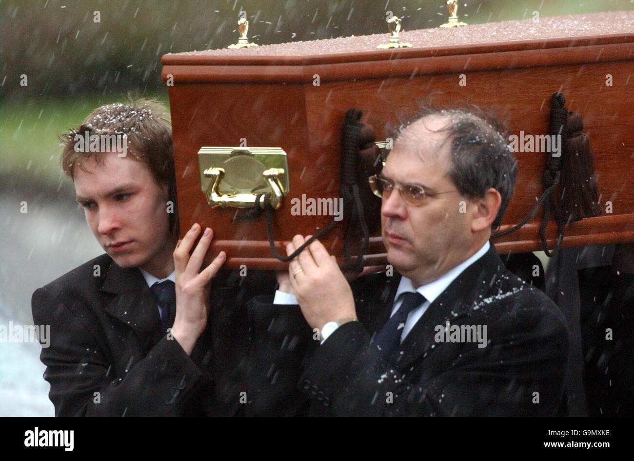 The coffin of Magnus Magnusson is carried from Baldernock Parish Church, on the outskirts of Glasgow. Stock Photo