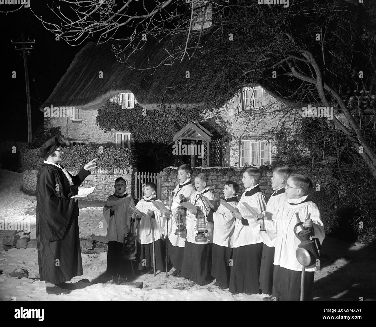 Undeterred by the snow underfoot, choristers of St. Andrew's Parish Church, Backwell, Somerset, led by their choirmistress, Mrs A Skinner, made an early start in their annual tour of carol singing around the village. Stock Photo