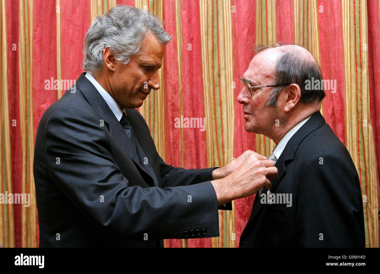 Nobel-winning British playwright Harold Pinter (right) is awarded the French Legion d'honneur by French Prime Minster Dominique de Villepin (left), at the French Embassy in London. Stock Photo