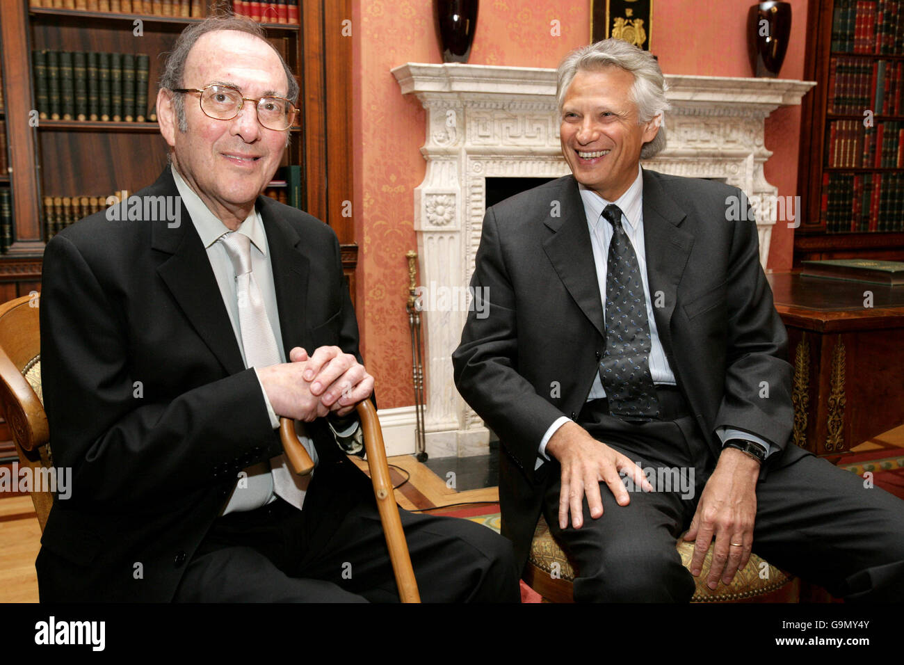 Nobel-winning British playwright Harold Pinter (left) shares a joke with French Prime Minister Dominique de Villepin (right) after being awarded the French Legion d'honneur at the French Embassy in London. Stock Photo