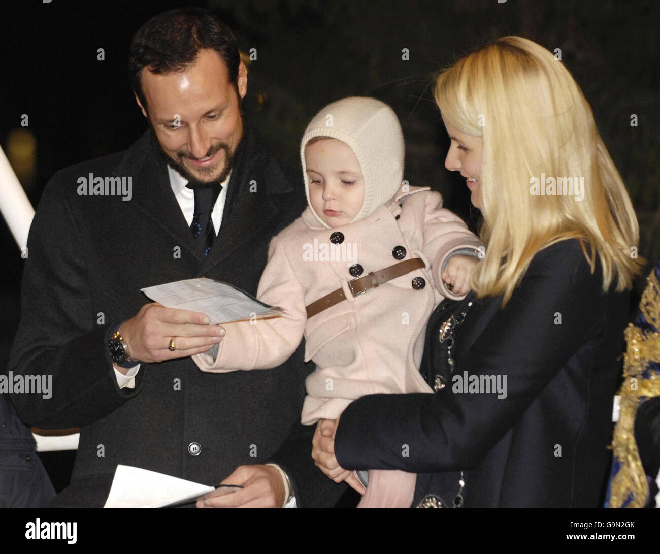 Princess Ingrid Alexandra of Norway is joined by her parents Crown Prince Haakon, left, and Crown Princess Mette-Marit reciting carols after switching on the lights of the christmas tree in Trafalgar Square in London. Stock Photo