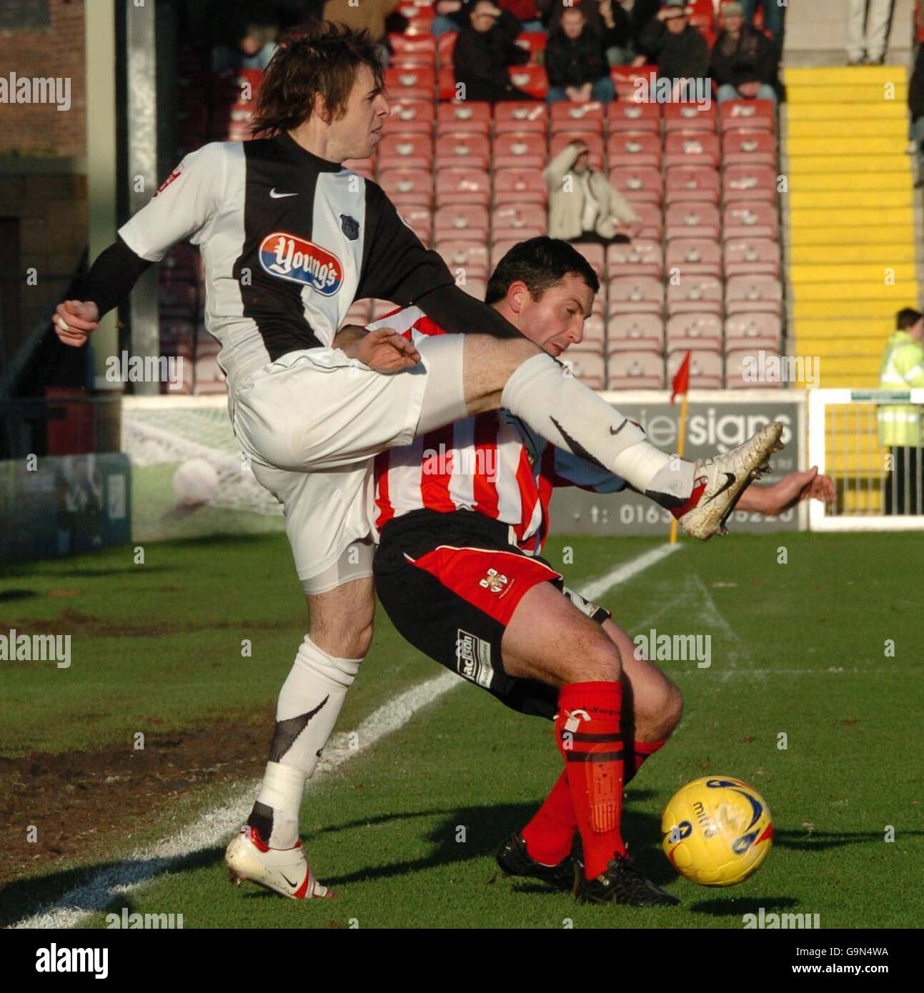 Lincoln's Nicky Eaden (right) and Grimsby's Tom Newey tussle for the ball during the Coca-Cola League Two match at Sincil Bank, Lincoln. Stock Photo