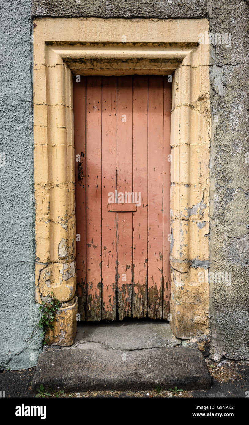 An old cottage rotting wooden door in stone frame Stock Photo Alamy