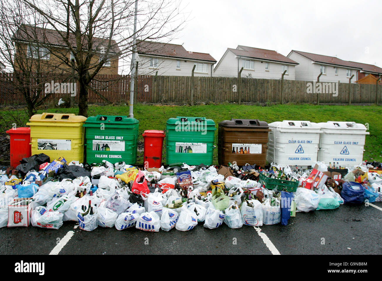 Overflowing bottle recycling banks in Denny, Central Scotland after the festive period. Stock Photo