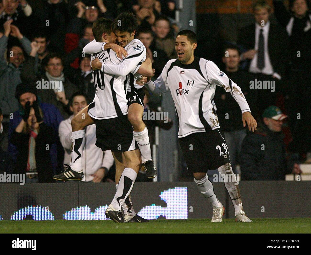 Fulham's Vincenzo Montella (center) celebrates with team mates Clint Dempsey (right) and Brian McBride after scoring the first goal of the match Stock Photo