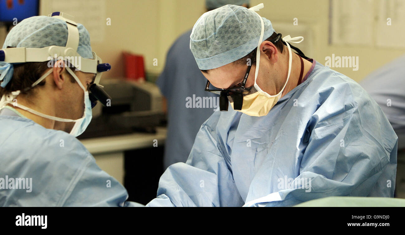 Surgeons perform an operation in an NHS hospital Stock Photo Alamy
