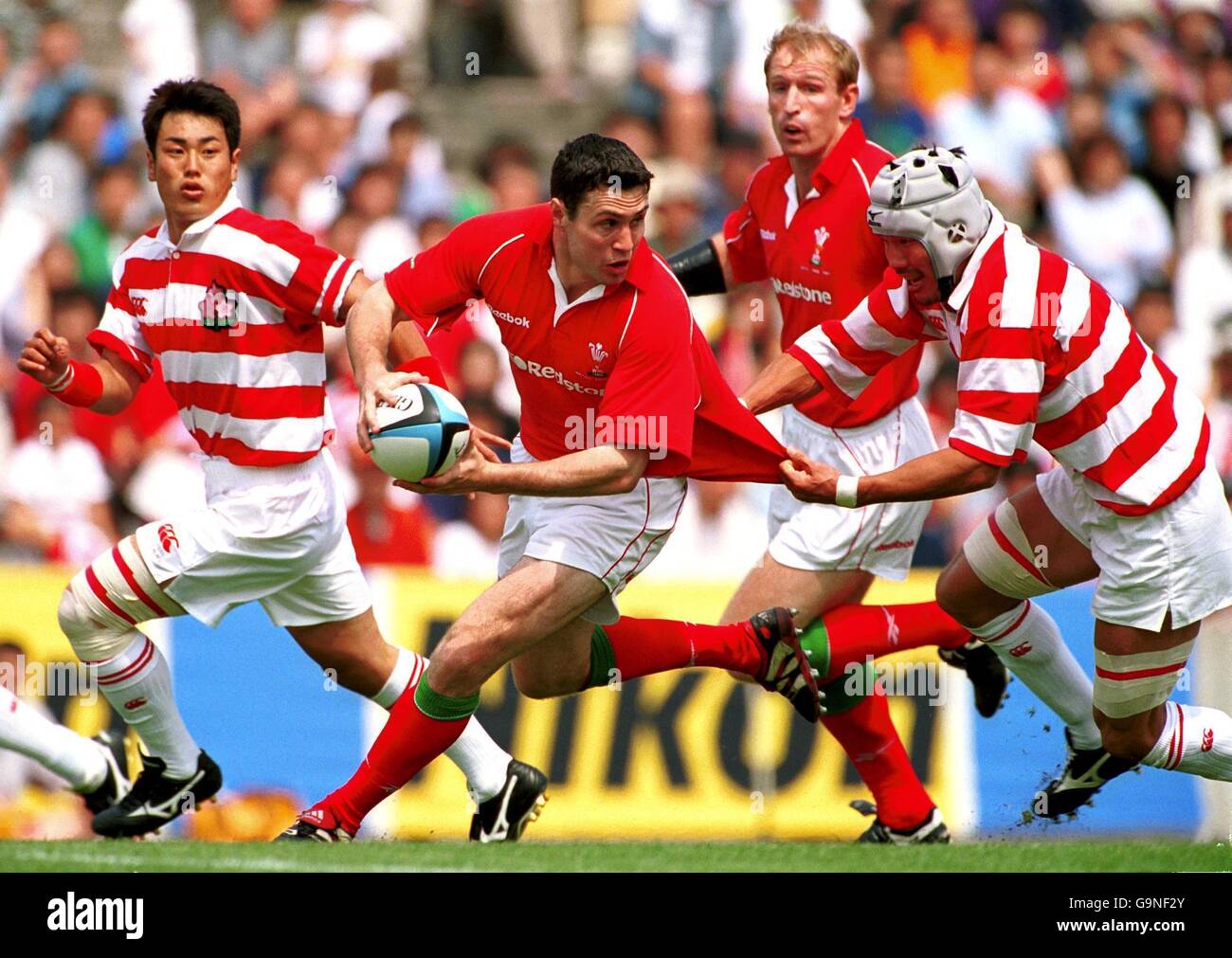 Rugby Union - Wales' Tour of Japan ; second test - Japan v Wales. Kazuya Koizumi of Japane tries to hold back Stephen Jones of Wales' Stock Photo