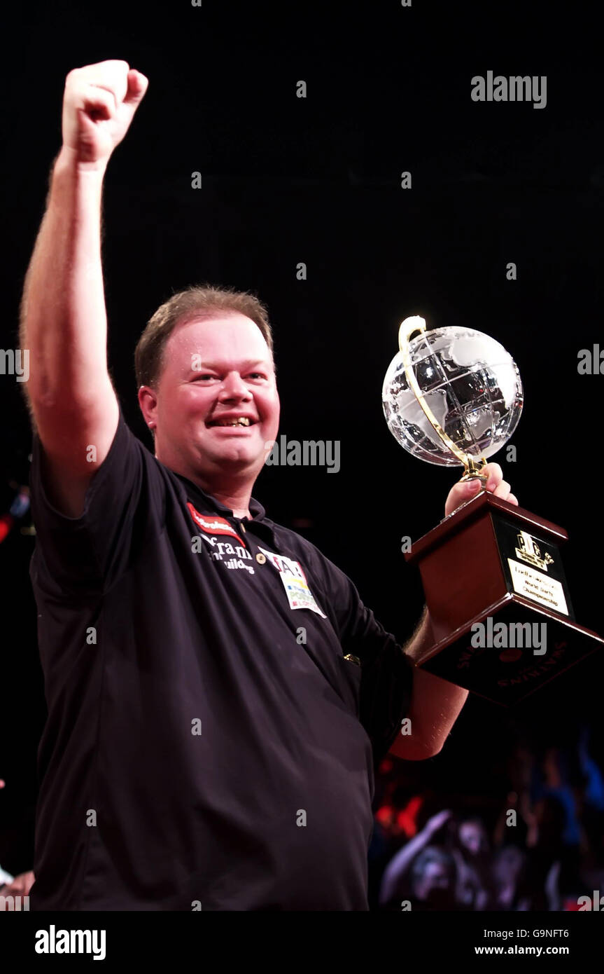 Netherlands' Raymond van Barneveld celebrates with the trophy following his  victory over England's Phil Taylor in the PDC Ladbrokes.com World  Championship Final at Purfleet, Essex Stock Photo - Alamy
