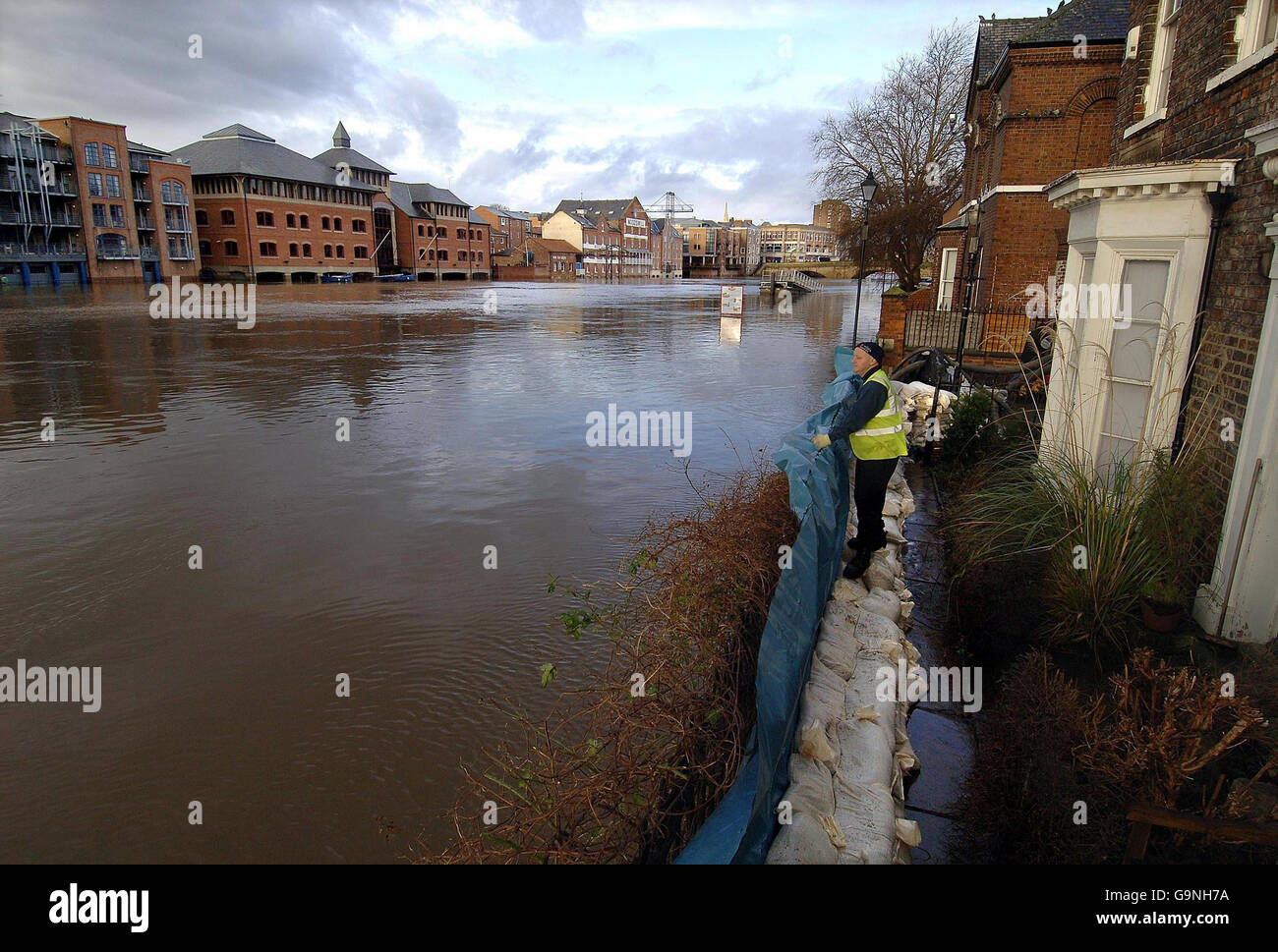 A York Council worker keeps an eye on the flooding, after workers have manned pumps around the clock to try and keep floodwater out of riverside properties, as the River Ouse in York continues to cause problems to the City today. Stock Photo