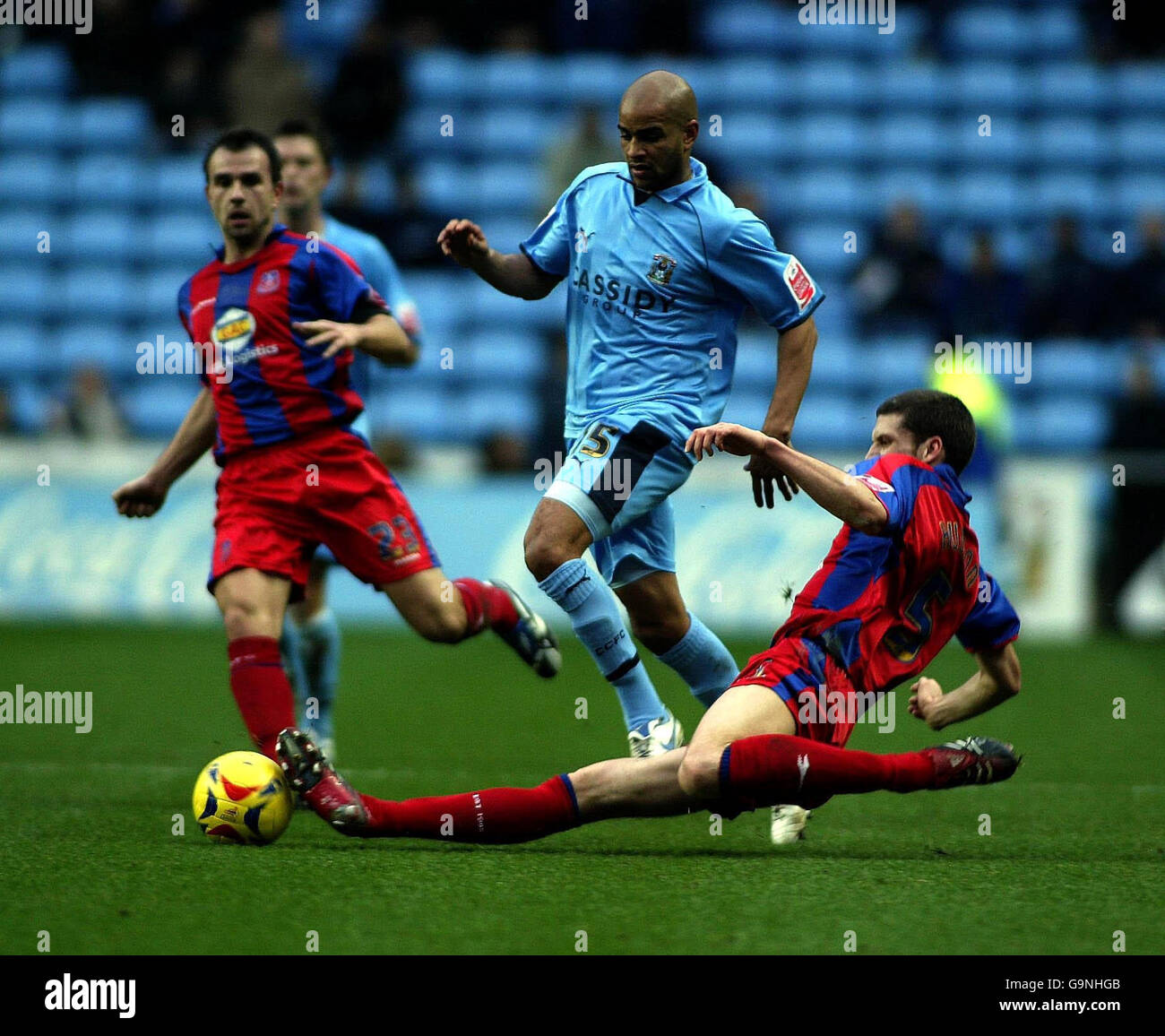 Coventry's Leon McKenzie (centre) is tackled by Crystal Palace's Mark Hudson (right) during the Coca-Cola Championship match at the Ricoh Arena, Coventry. Stock Photo