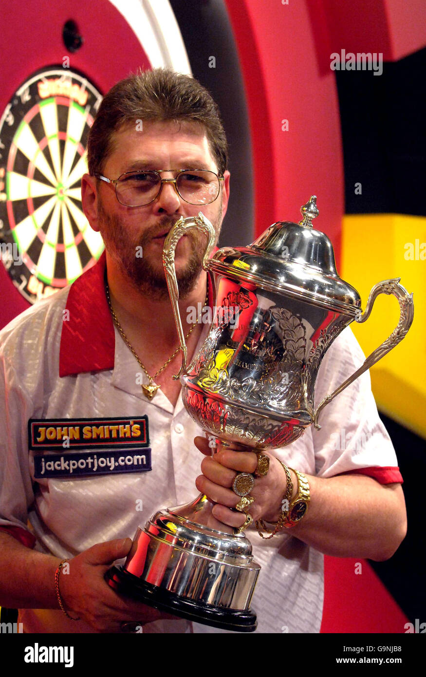 Matin Adam's celebrates by kissing his throphy after winning the final of the Lakeside World Professional Darts Championship at Frimley Green, London. Stock Photo