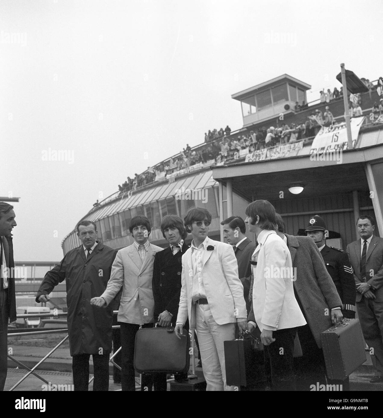 Two hundred and fifty screaming fans wlecomed the Beatles from the balcony of the Queen's Building at London Airport when they arrived back from their American tour. Left to right: Paul McCartney, George Harrison, John Lennon and Ringo Starr. Stock Photo