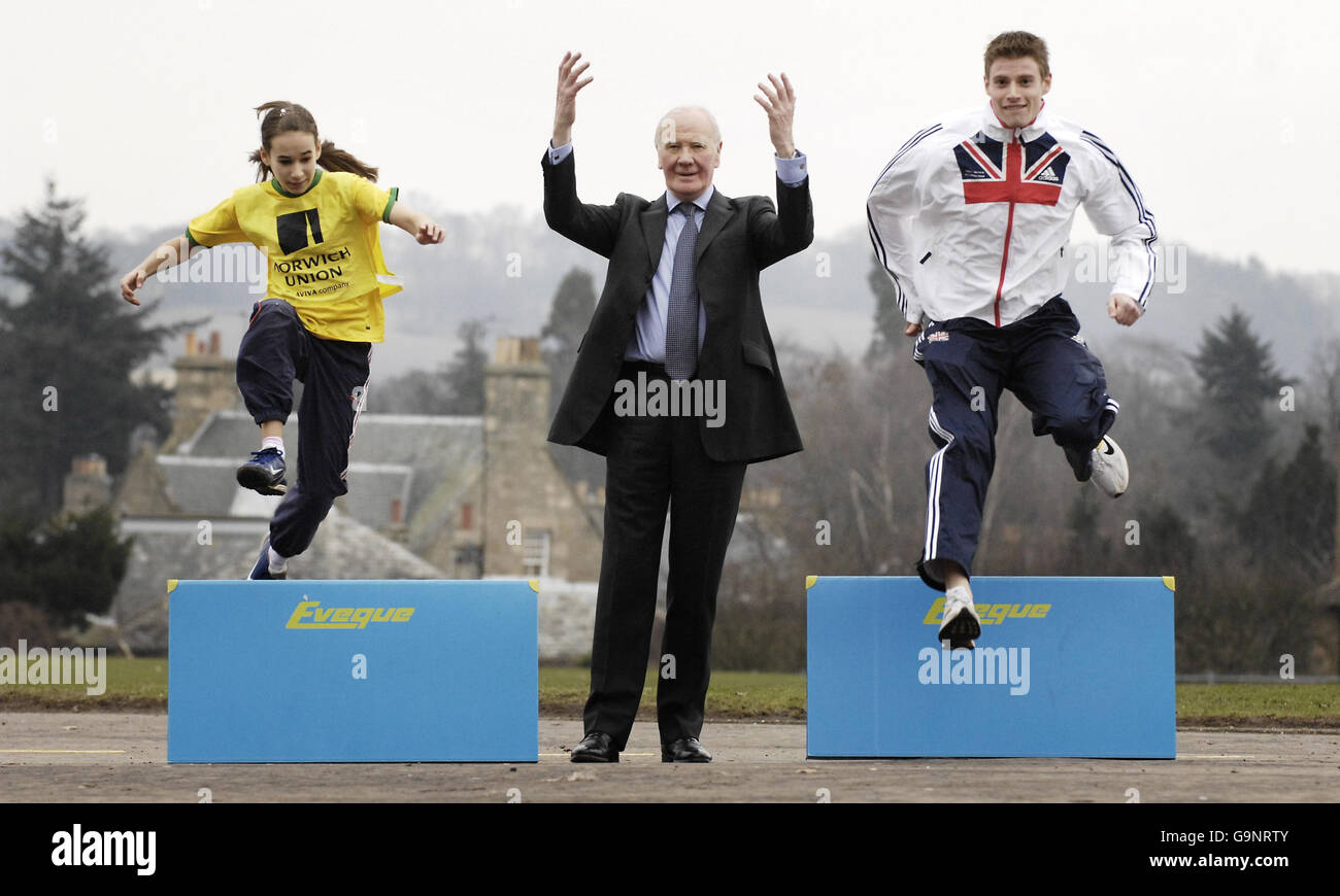 Sir Menzies Campbell (centre) with 110m hurdler Allan Scott (right) and 12-year-old Isabella Monteith at Bell Baxter High School in Fife, Scotland, where they visited the Grassroots Athletics roadshow. Stock Photo