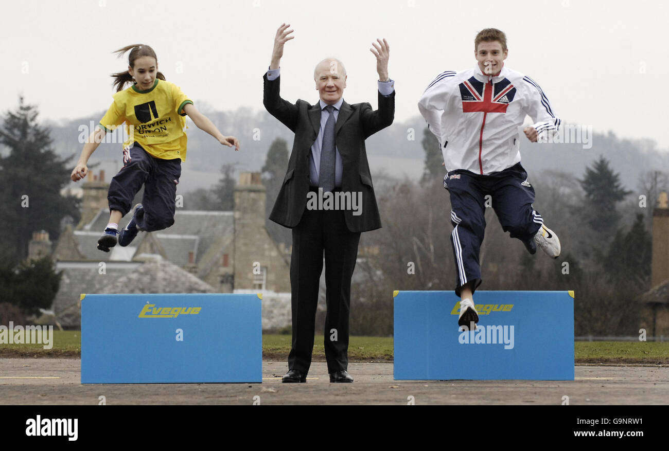 Sir Menzies Campbell (centre) with 110m hurdler Allan Scott (right) and 12-year-old Isabella Monteith at Bell Baxter High School in Fife, Scotland, where they visited the Grassroots Athletics roadshow. Stock Photo