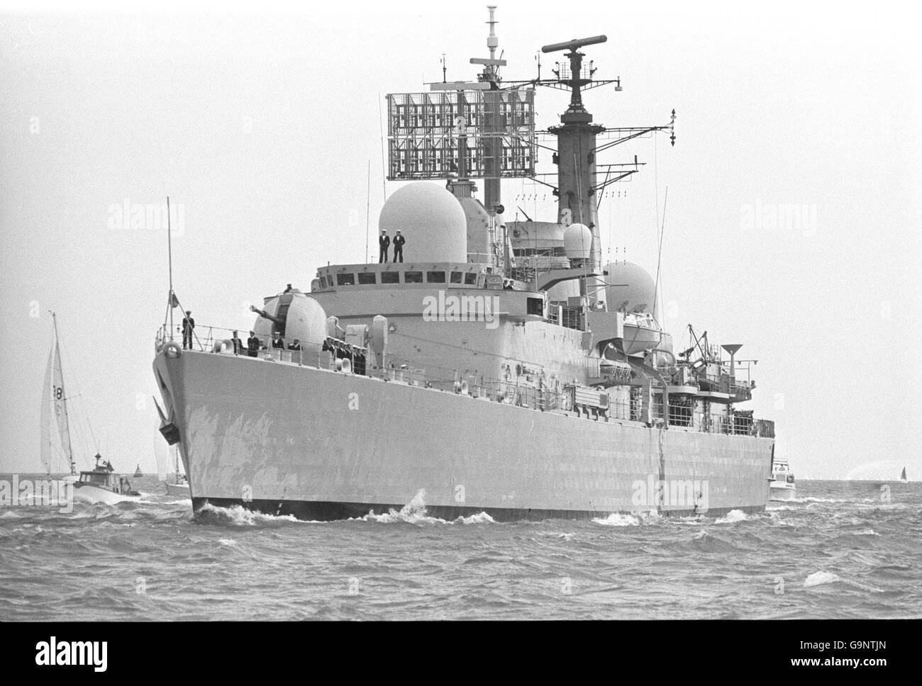 Small craft welcome the Type 42 destroyer HMS Glasgow as she limped back into Portsmouth from the Falklands conflict. Stock Photo