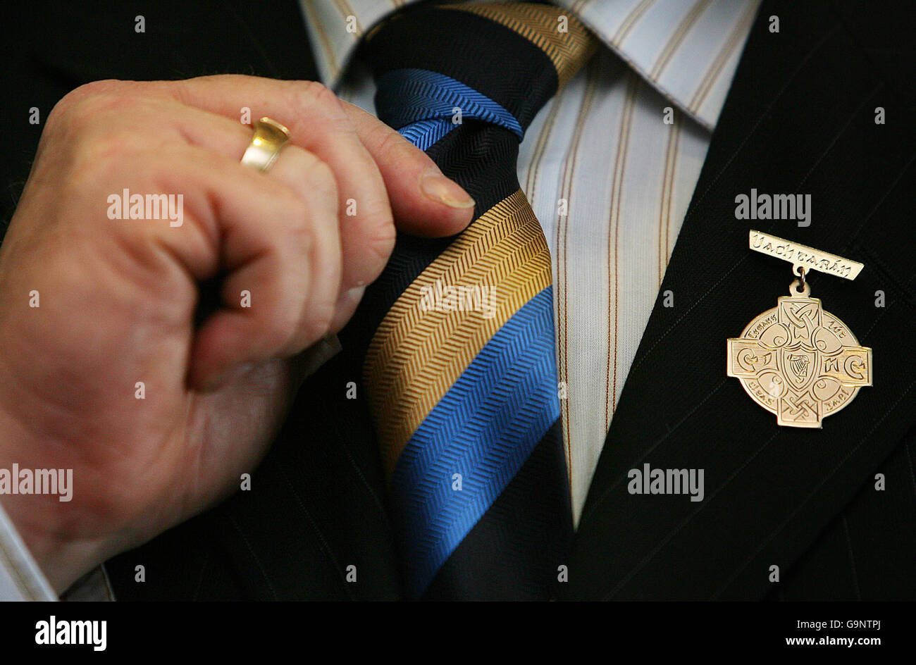 GAA President Nicky Brennan adjusts his tie with a medal of the GAA on his lapel at a press conference where increased Croke Park ticket prices were discussed. Stock Photo
