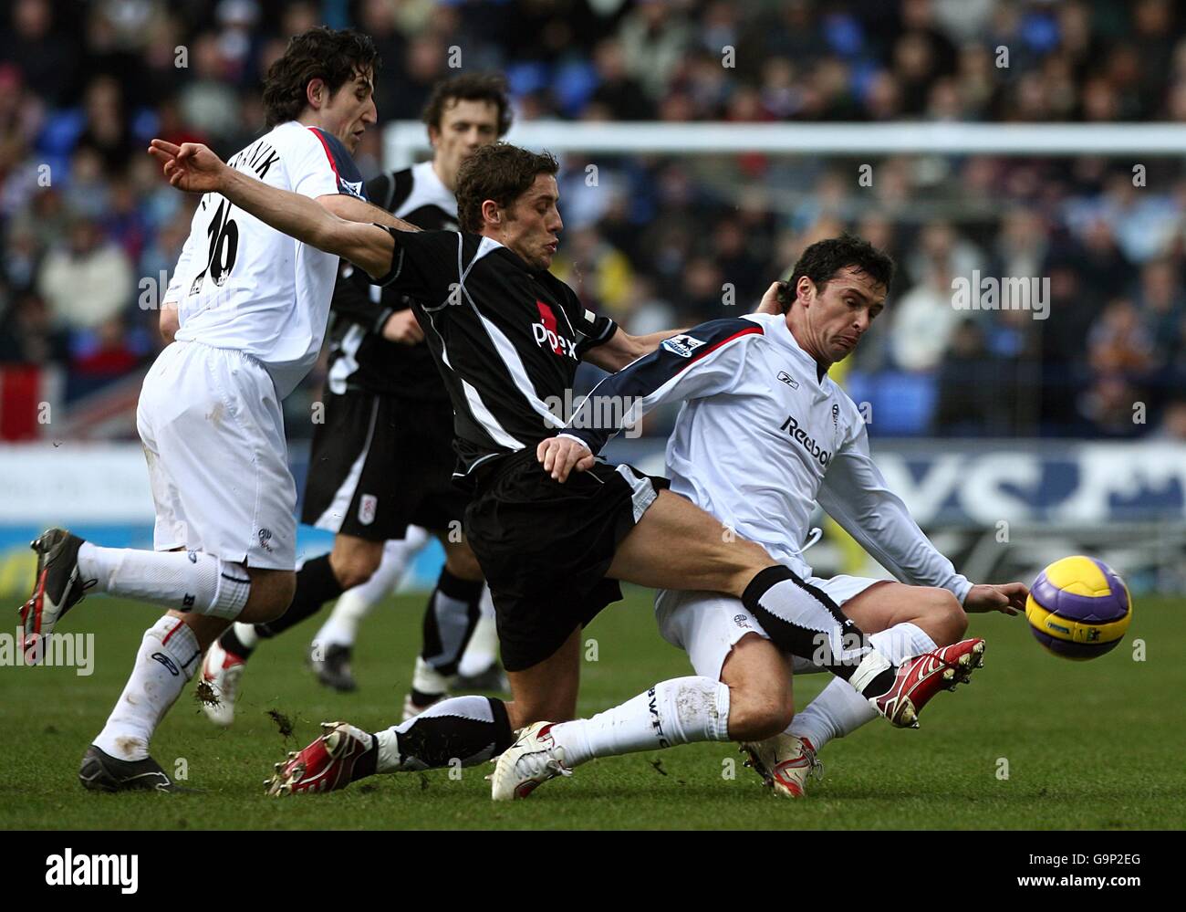 Fulham's Michael Brown (center) and Bolton Wanderers' Gary Speed (right) battle for the ball, as Bolton's Andranik Teymourian (left) follows Stock Photo