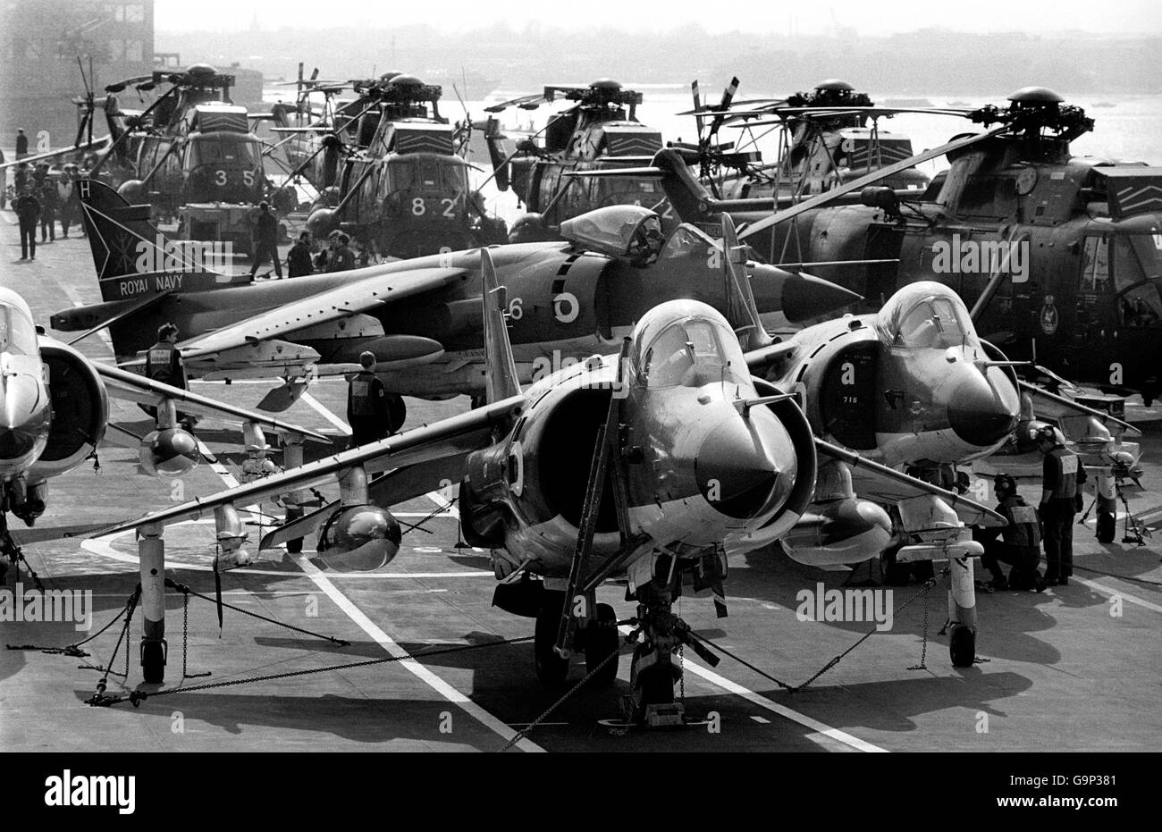 BAe Sea Harrier FRS.Mk.1's on the flight deck of the carrier HMS Hermes, with Westland Sea King helicopters behind, as she headed south for the Falklands. Stock Photo