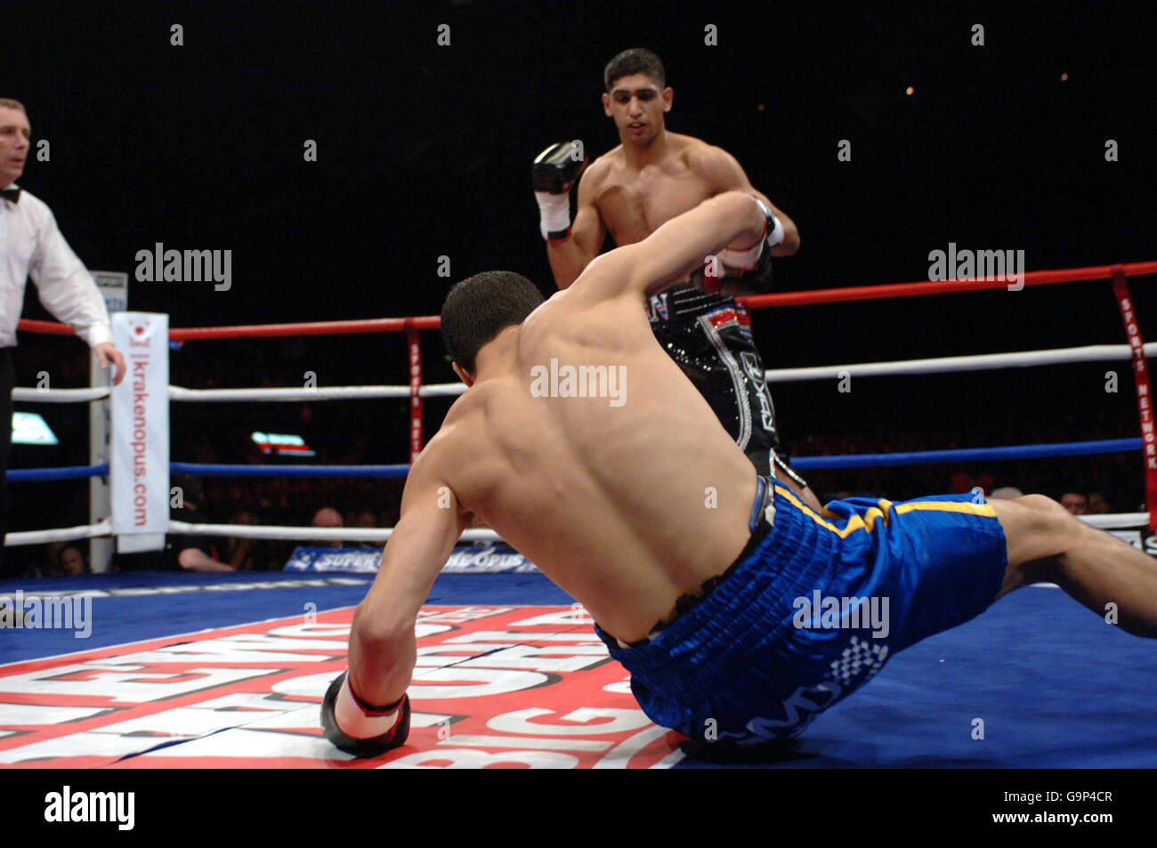 Bolton's Amir Khan knocks down France's Mohammed Medjani during the Light-Welterweight fight at the Wembley Arena, London. Stock Photo