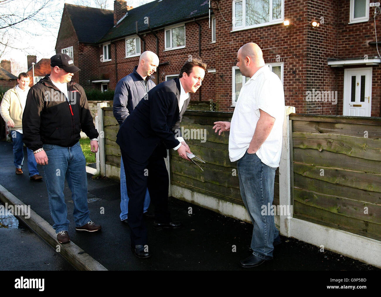 Leader of the Conservative Party David Cameron (centre) stops to pick up litter during his visit to the Benchill area of Wythenshawe, Manchester. Stock Photo