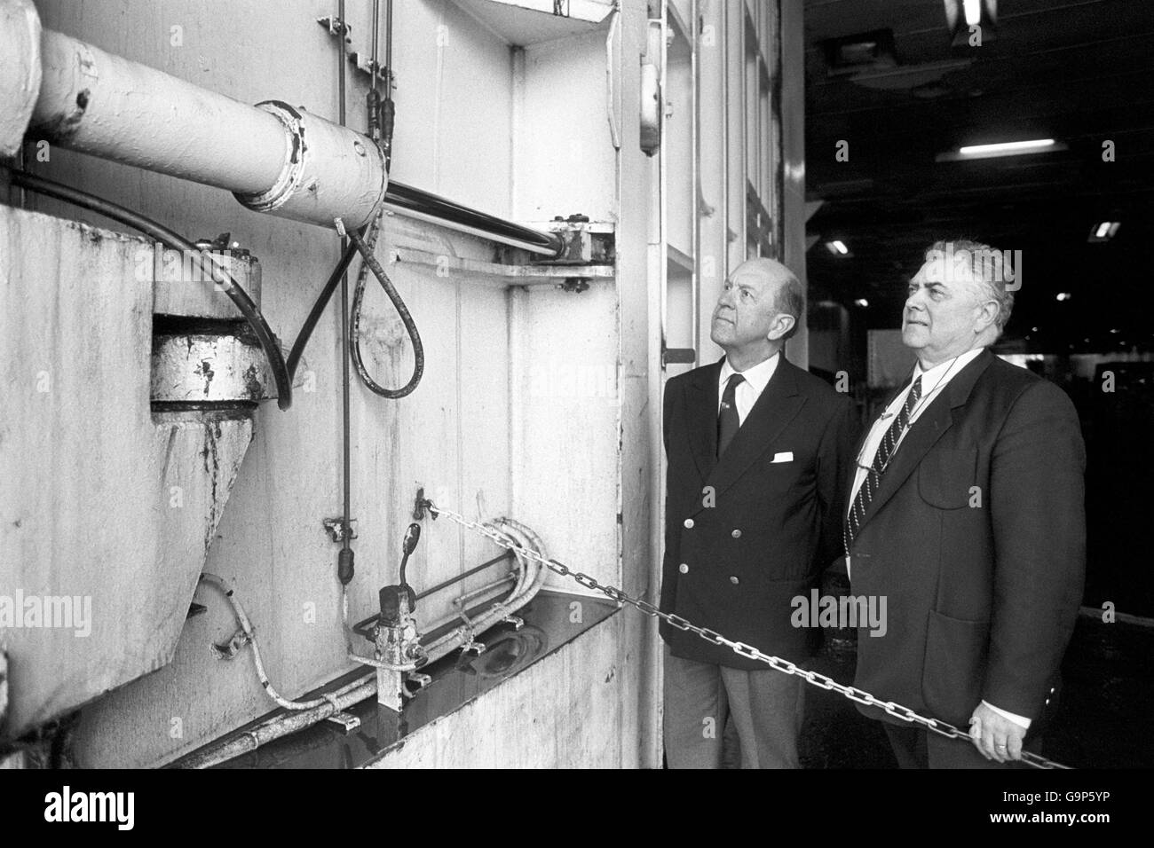 British High Court judge Mr Justice Sheen, appointed to head the British inqury into the capsizing of the Herald of Free Enterprise, with Belgian judge Arthur D'Hoest (r), head of his country's investigation into the disaster watches the bow doors being operated on board the car ferry's sister ship, the Pride of Free Enterprise. Stock Photo
