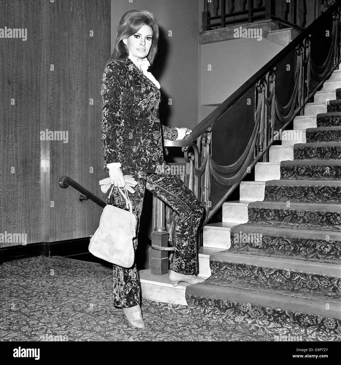 Raquel Welch wears a patterned velvet trouser suit for a gala opening of the film Murderers Row at the Leicester Square Theatre Stock Photo
