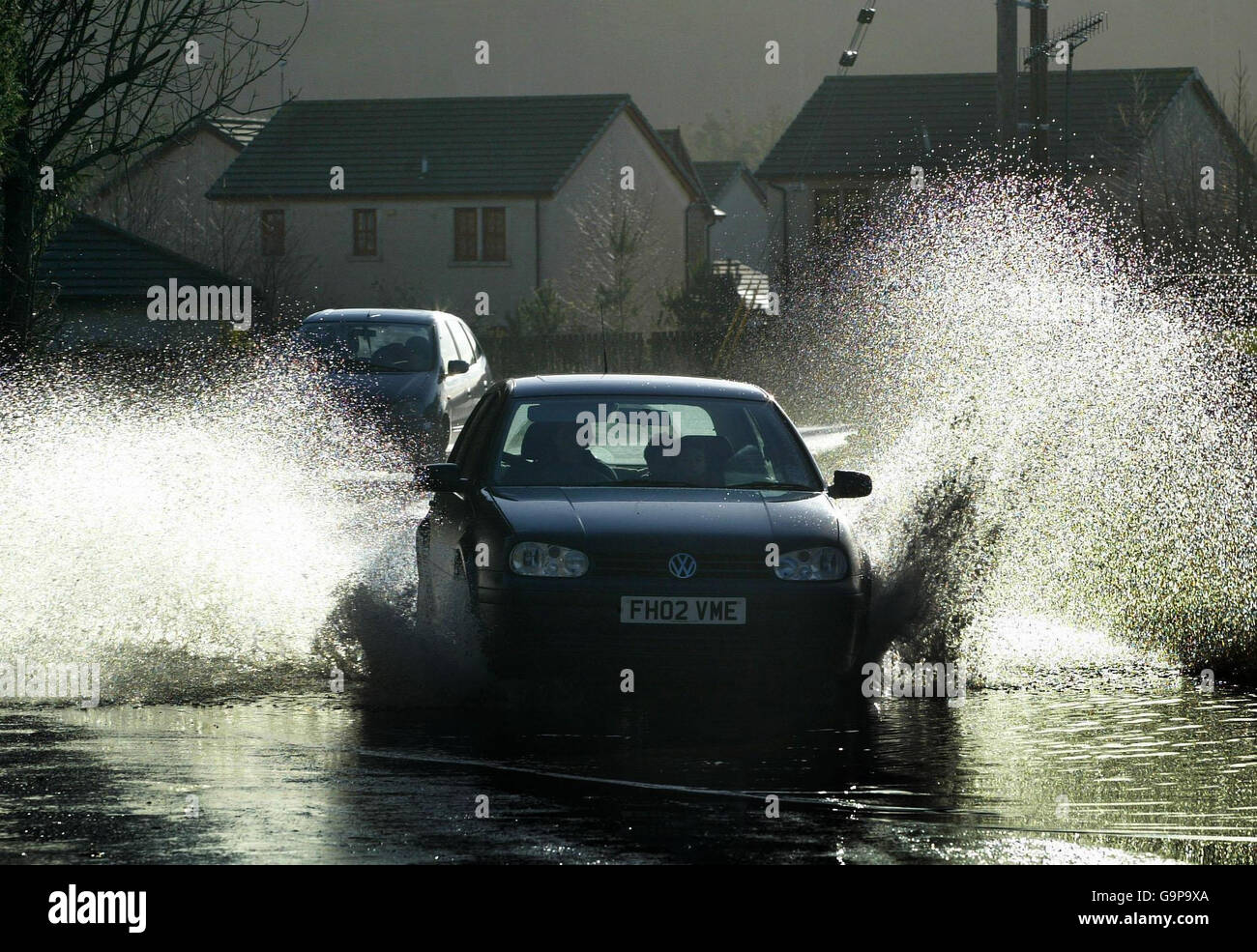 Drivers make their way through deep water after heavy over-night rain and storms bring flooding to areas of the Scottish Borders. Stock Photo